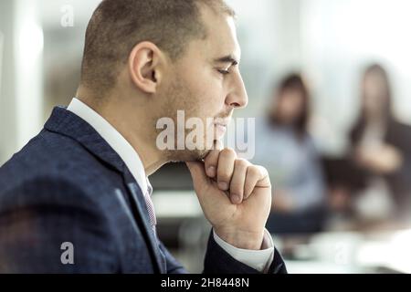 senior Manager at the workplace on the background of business team Stock Photo