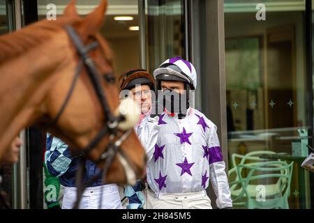 Ascot, Berkshire, UK. 19th November, 2021. Jockey William Kennedy wearing his face mask as he leave the Jockey's Weighing Room ready to race in the Ascot Shop National Hunt Maiden Hurdle Race at Ascot. Credit: Maureen McLean/Alamy Stock Photo