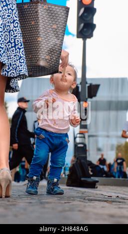 A little girl eats ice cream on the Champs Elysees Stock Photo