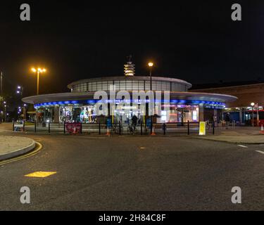 A night shot of Southgate tube station with the road in the foreground. The station is an Art Deco station designed by Charles holden. Piccadilly line Stock Photo