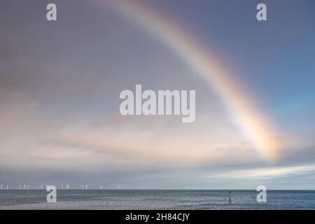 Rainbow over the Gwynt-y-Môr offshore wind farm in Colwyn Bay, North Wales Stock Photo