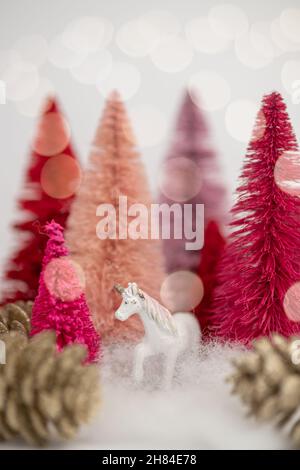 Six Mini Pink and Red Bottle Brush Christmas Trees on White Background With Bokeh Lights Vertical Stock Photo