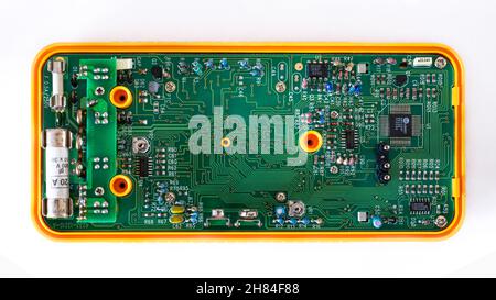 Detailed image of an electronic circuit of a multimeter for measurements of electric currents and  voltage. Stock Photo