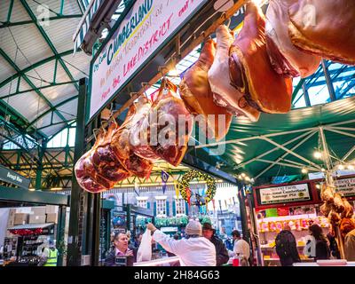 BOROUGH MARKET CHRISTMAS HAM Legs of dry cured Cumberland hams hanging display Borough Market Meat Stall hams air curing on display for sale and selling at Festive Christmas Borough Market  butchers stall Southwark London UK Stock Photo