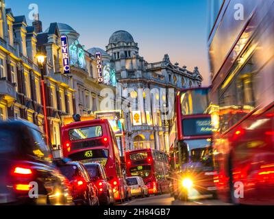 SHAFTESBURY AVENUE NIGHT LONDON TRAFFIC ULEZ POLLUTION  Theatreland West End theatres busy heavy pollution diesel fumes gridlock with red buses  taxis and private vehicles in Shaftesbury Avenue at dusk West End London UK