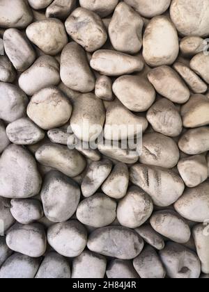 An outside wall covered with stones Stock Photo