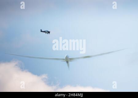 a small single engine private plane  flying over a glider Stock Photo