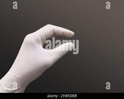 Closeup Image Of Medical Latex Surgical Glove In Hand. Isolated Grey Background. Selective Focus Stock Photo