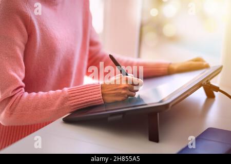 Woman drawing design on digital graphic tablet Stock Photo