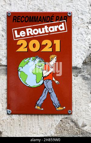 Martel, France - June 24, 2021: Le Routard guide 2021 sign on a wall. Le Routard guide is a French collection of tourist guides Stock Photo