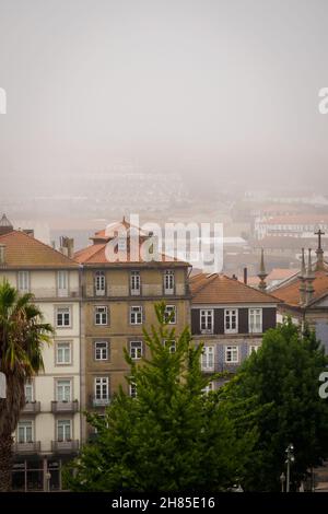 Morning mist over the buildings of central Porto, Portugal Stock Photo