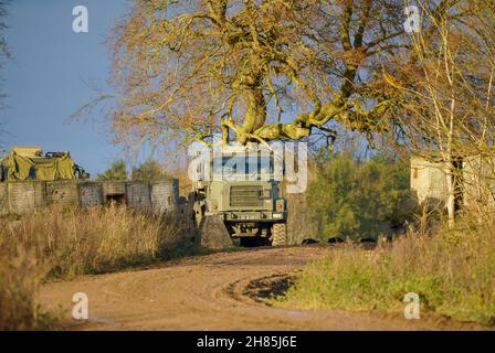 British army Oshkosh 1070F (8×8) heavy equipment transporter (HET) parked in a woodland camp, Salisbury Plain Wiltshire UK Stock Photo