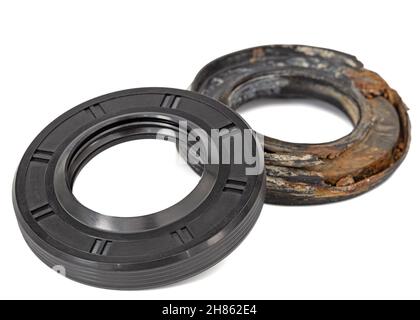 New and old oil seals for machine repair, isolated on white background Stock Photo