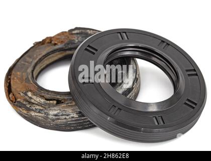 New and old oil seals for machine repair, isolated on white background Stock Photo