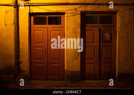 Two wooden doors at night on the street Stock Photo