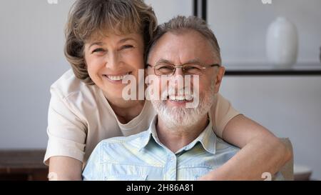 Happy husband and wife looking at camera with toothy smiles Stock Photo