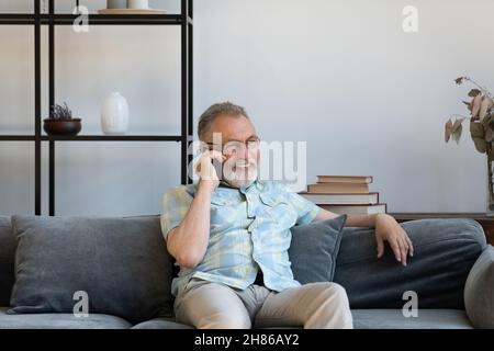 Happy elder grandfather talking on mobile phone Stock Photo