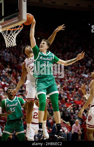 BLOOMINGTON, UNITED STATES - 2021/11/27: Marshall Thundering Herd forward Mikel Beyers (31) dunks against Indiana Hoosiers forward Trayce Jackson-Davis (23) during an NCAA basketball game on November 27, 2021 in Bloomington, Ind. IU beat Marshall 90-79. Stock Photo