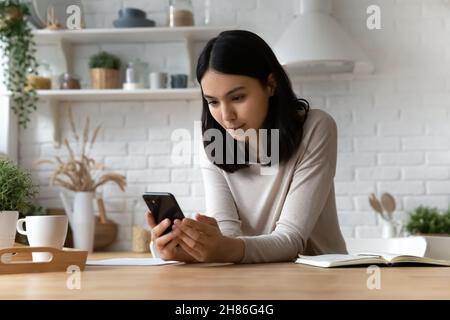 Young Asian woman read online social media news on cellphone Stock Photo