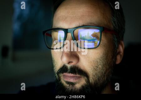 Crypto trader investor analyst looking at computer screen analyzing financial graph data on pc monitor, thinking of online stock exchange market  Stock Photo