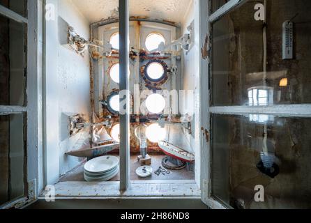 Old items in front of a ice proof window at Märket lighthouse, Ahvenanmaa, Finland Stock Photo