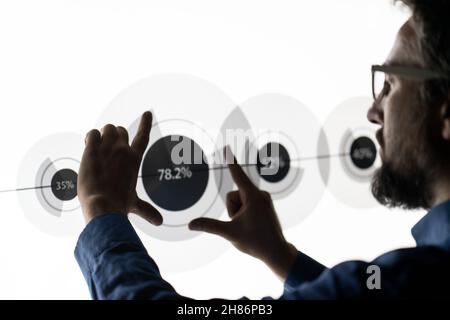 Close up of businessman hand using creative business chart hologram on blurry city background. Innovation, finance, trade, future. Stock Photo