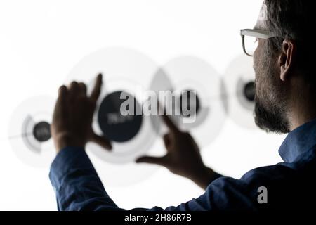Close up of businessman hand using creative business chart hologram on blurry city background. Innovation, finance, trade, future. Stock Photo