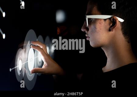 Close up of businessman hand using creative business chart hologram on blurry city background. Innovation, finance, trade, future. Stock Photo