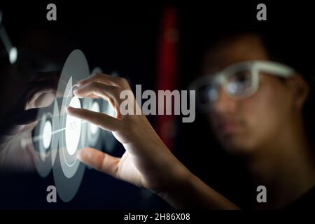 Close up of businessman hand using creative business chart hologram on blurry city background. Innovation, finance, trade, future. Stock Photo