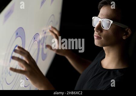 Close up of businessman hand using creative business chart. Innovation, finance, trade, future, ai and technology concept. Double exposure.  Stock Photo