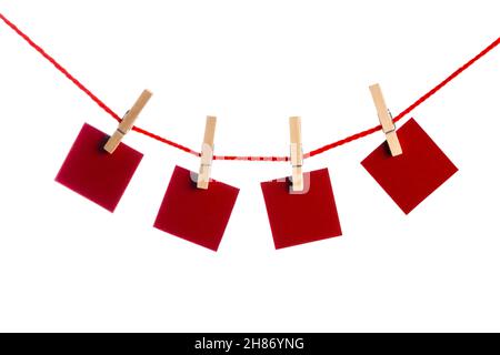 Red Memo papers with clothespins on a leash. Isolated on white background. Love copy space for letters Stock Photo