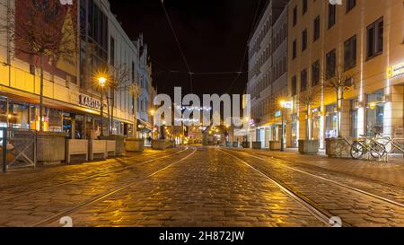 Augsburg, Germany - Nov 27th 2021: Old town streets in Augsburg, Bavaria, are decorated for holiday season. Christmas lights are installed above stree Stock Photo