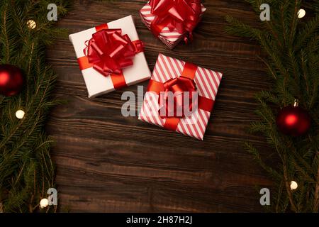 three Christmas boxes on a wooden background . photo with a copy-space. Stock Photo