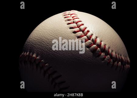 Macro close-up baseball ball isolated on black background. Stock Photo