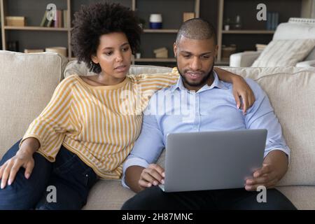 Young African American couple using laptop computer at homes Stock Photo