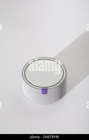 Smart speaker Yandex mini on white table.  Stock Photo