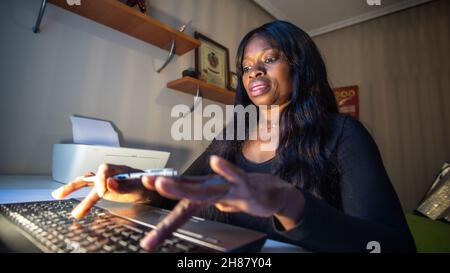 African woman works on a computer Stock Photo