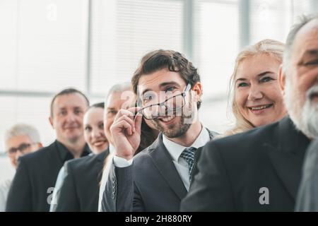 close up. smiling businessman standing in a row with his colleagues Stock Photo