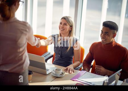 A commission is getting know with a female candidate during an interview for a job in a pleasant atmosphere. Business, people, company Stock Photo