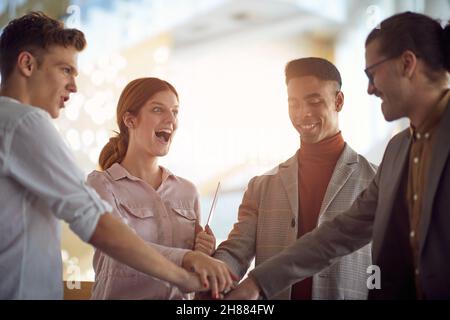 A group of young business people having a good time in a friendly atmosphere in the hallway together. Business, people, company Stock Photo