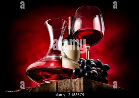 Wine in a decanter and glass on a wooden table Stock Photo