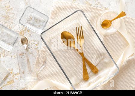Set of stylish dinnerware on light grunge background Stock Photo