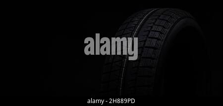 image photograph of a black tire on a black background Stock Photo