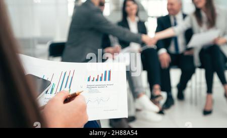 close up. businesswoman with a financial report at a working meeting with the business team. Stock Photo