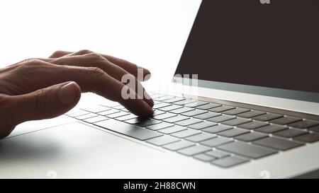 close up. modern man works on a laptop. Stock Photo
