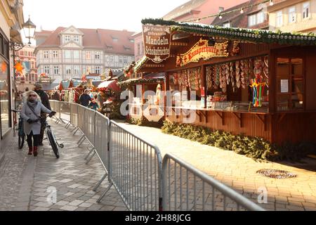 Quedlinburg, Germany. 28th Nov, 2021. People visit the fenced Christmas market in the Advent city of Quedlinburg. The Christmas market belongs to a total of two markets under particularly high Corona conditions in the district of Harz have received a permit to open. Credit: Matthias Bein/dpa-Zentralbild/dpa/Alamy Live News Stock Photo