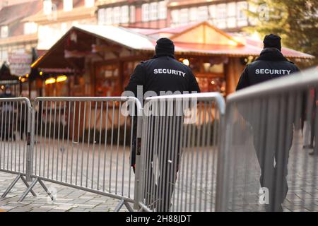 Quedlinburg, Germany. 28th Nov, 2021. Employees of a security company patrol a fenced Christmas market in the Advent city of Quedlinburg. The Christmas market belongs to a total of two markets under particularly high Corona conditions in the district of Harz have received a permit to open. Credit: Matthias Bein/dpa-Zentralbild/dpa/Alamy Live News Stock Photo