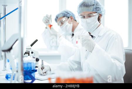 close up. group of laboratory technicians conduct testing in the laboratory . Stock Photo