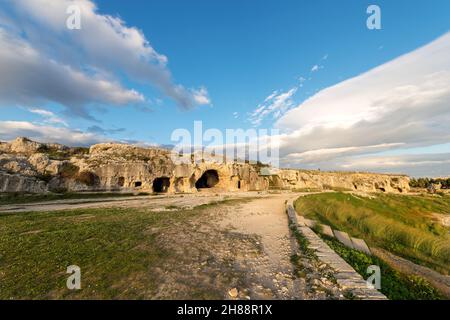 Artificial caves (grotta del Ninfeo - cave of the Nymphaeum). Greek Roman Amphitheater in Syracuse city (Siracusa), Sicily island, Italy, Europe. Stock Photo