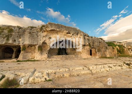 Artificial caves (grotta del Ninfeo - cave of the Nymphaeum). Greek Roman Amphitheater in Syracuse city (Siracusa), Sicily island, Italy, Europe. Stock Photo